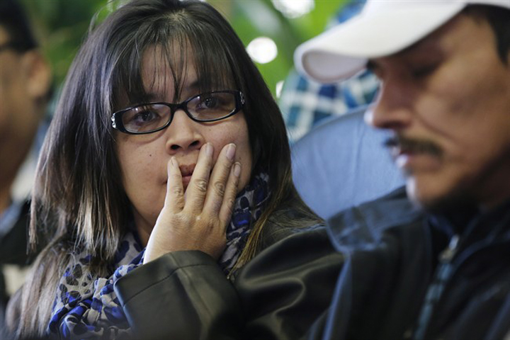 Julie and Caesar Harper, parents of Rinelle Harper, listen as Grand Chief David Harper speaks at a press conference in Winnipeg on Thursday.