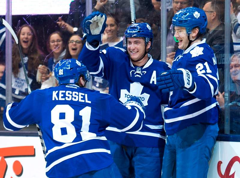Toronto Maple Leafs forward James van Riemsdyk (21) celebrates a goal with teammates Phil Kessel (81) and Tyler Bozak (42) while playing against the Boston Bruins during second period NHL hockey action in Toronto on Wednesday, November 12, 2014. 