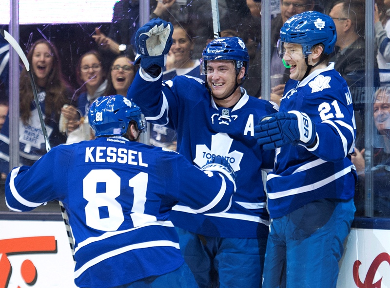 Toronto Maple Leafs forward James van Riemsdyk (21) celebrates a goal with teammates Phil Kessel (81) and Tyler Bozak (42) while playing against the Boston Bruins during second period NHL hockey action in Toronto on Wednesday, November 12, 2014. 