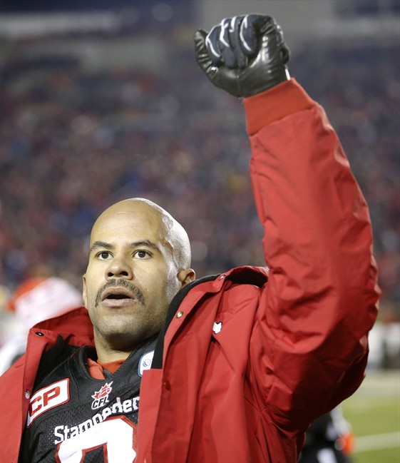 Calgary Stampeders' Jon Cornish raises arm to the crowd during the closing seconds of the CFL Western Final against the Edmonton Eskimos in Calgary, Alta., Sunday, Nov. 23, 2014. To capture their first Grey Cup title since 1999, the Hamilton Tiger-Cats will have to corral Calgary running back Jon Cornish.THE CANADIAN PRESS/Larry MacDougal.