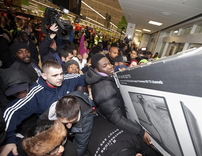 Shoppers jostle for electrical goods at a store in London, Friday Nov. 28, 2014. 