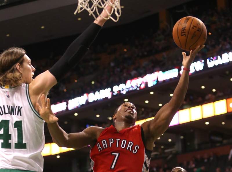 Kyle Lowry #7 of the Toronto Raptors drives to the basket against Kelly Olynyk #41 of the Boston Celtics in the second half at TD Garden on November 5, 2014 in Boston, Massachusetts. 