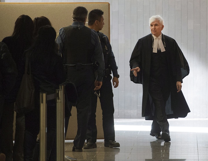 Defence lawyer Luc Leclair, right, enters the courtroom to begin his case at the murder trial for Luka Rocco Magnotta Friday, Oct. 31, 2014 in Montreal.