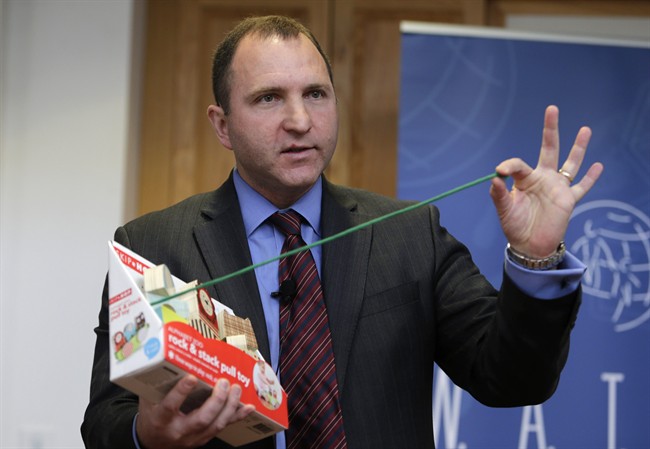 James Swartz, director of World Against Toys Causing Harm Inc., holds up a string on a children's pull toy at Children's Franciscan Hospital in Boston, Wednesday, Nov. 19, 2014.