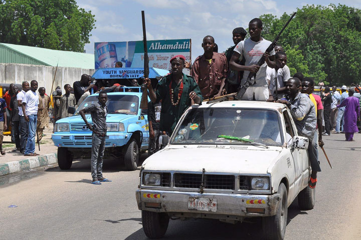 Vigilante and local hunters armed with guns patrol the streets of Maiduguri, Nigeria, Thursday, Sept. 4, 2014. 