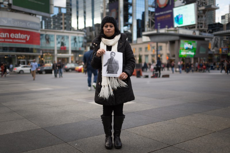 Pam Shiraldini poses for a portrait holding a photograph of her husband, Masoud Hajivand, shortly before the rally in Toronto's Dundas Square to protest Masoud's impending deportation to Iran.