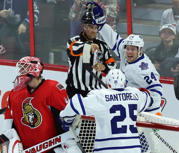 Toronto Maple Leafs Peter Holland (24)celebrates his goal with teammate Mike Santorelli (25) as Ottawa Senators goaltender Craig Anderson looks on during first period NHL hockey in Ottawa Sunday November 9, 2014. 