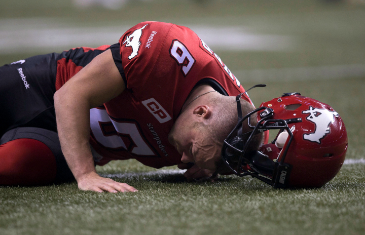 Calgary Stampeders punter Rob Maver reacts to taking a hit during the 102nd Grey Cup against the Hamilton Tiger-Cats in Vancouver, B.C. Sunday, Nov. 30, 2014. 