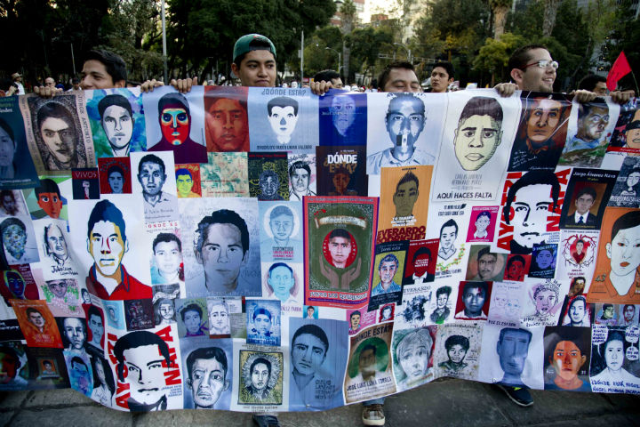 Demonstrators march holding images of missing students in protest for the disappearance of 43 students in the state of Guerrero, in Mexico City on Wednesday.