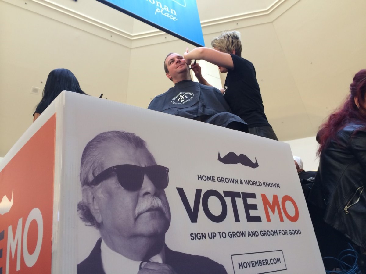 A man getting a clean shave at a 2014 Movember kick-off event.