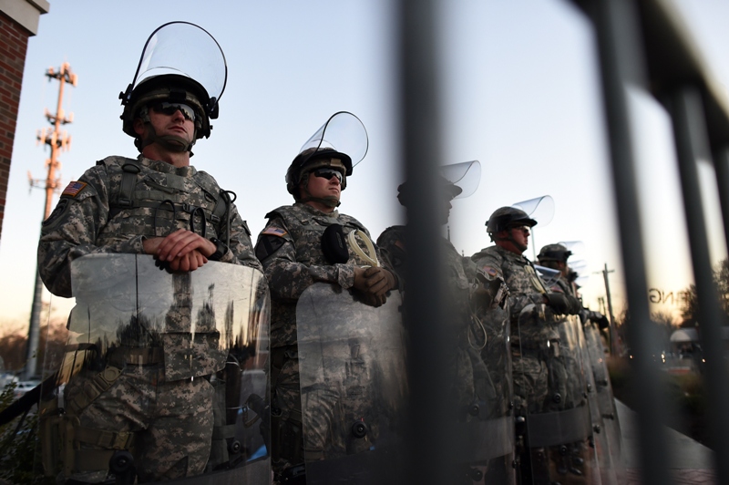 National Guard troops secure the police station in Ferguson, Missouri, a day after violent protests and looting following the grand jury decision in the fatal shooting of an 18-year-old black teenager Michael Brown.