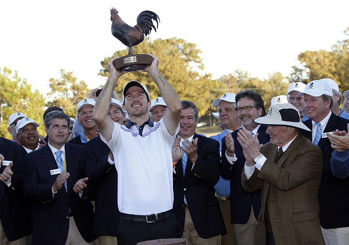 Nick Taylor hoists the trophy after winning the Sanderson Farms Championship trophy Sunday, Nov. 9, 2014, in Jackson, Miss.