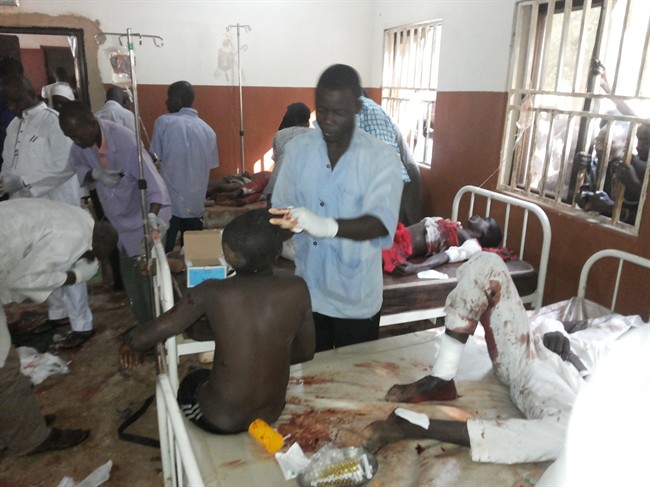 People are treated at the General hospital in Potiskum, Nigeria, Monday, Nov. 10, 2014, following a suicide bomb attack at Government Science Technical College Potiskum. 