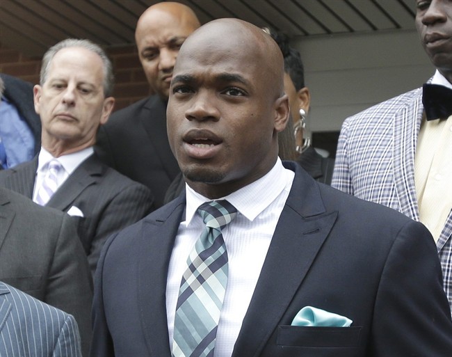FILE - In this Nov. 4, 2014, file photo, Minnesota Vikings running back Adrian Peterson speaks to the media after pleading no contest to an assault charge in Conroe, Texas. The NFL suspended Adrian Peterson without pay for at least the remainder of the season. 