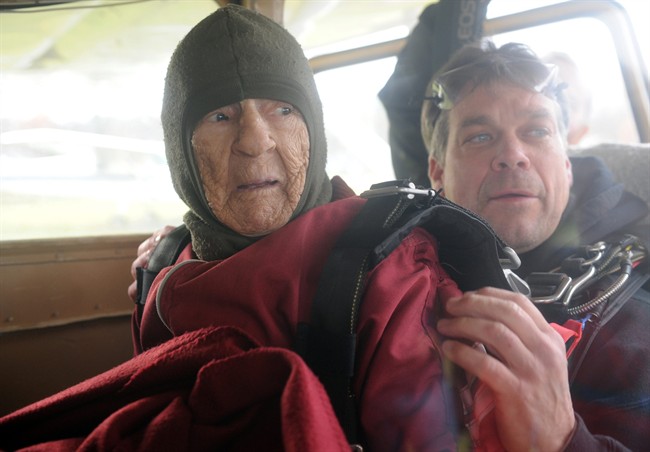In this Saturday, Nov. 8, 2014 photo, Eleanor "Nanny" Cunningham, left, with co-parachuter Dean McDonald, get situated in the plane prior to their skydive in Gansevoort, N.Y.