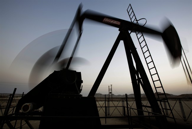  In this Oct. 14, 2014 file photo, an oil pump works at sunset in the desert oil fields of Sakhir, Bahrain. 