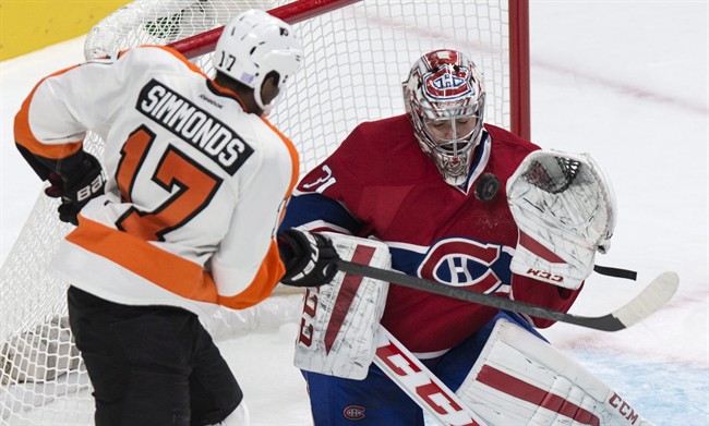 Montreal Canadiens goalie Carey Price stops a shot by Philadelphia Flyers' Wayne Simmonds during the second period of their NHL hockey game in Montreal on Saturday, Nov. 15, 2014.