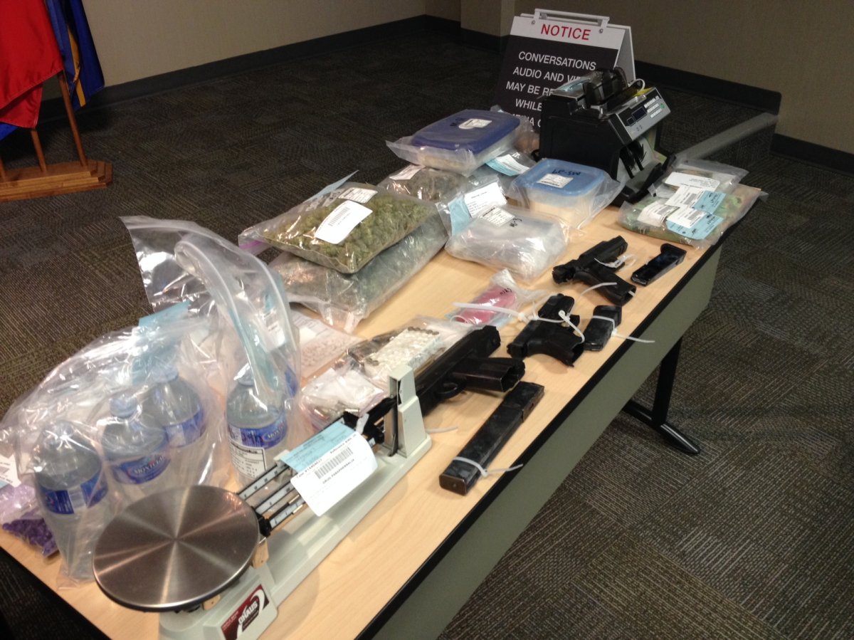 Calgary police display drugs and weapons seized from a home in the city's southwest.