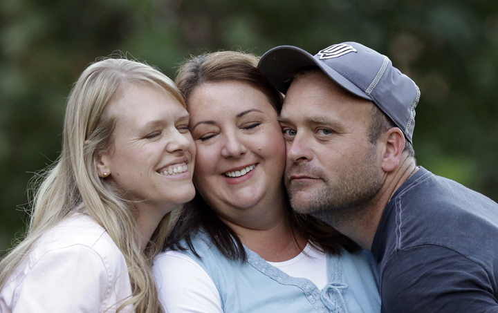 Brady Williams poses with two of his wives, from left to right, Robyn and Rosemary, in September 2013.