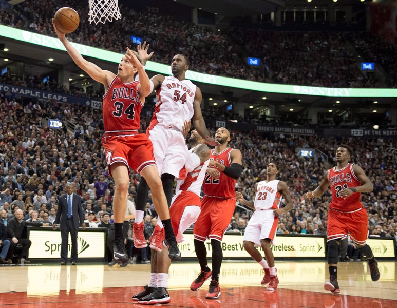 Chicago Bulls forward Mike Dunleavy (34) soars to the hoop past Toronto Raptors Patrick Patterson (54) during second half NBA action in Toronto on Thursday November 13, 2014. 