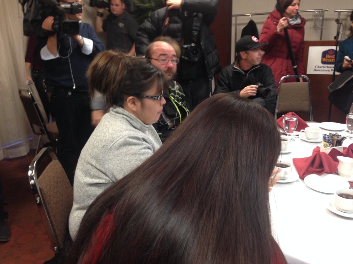 Rinelle Harper (front, in red), and her mother, Julie, meet one of her rescuers on Nov. 20.