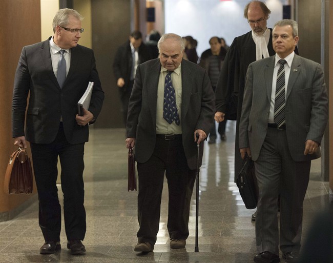 Dr. Joel Paris, center, a psychiatrist who examined Luka Magnotta, leaves the courtroom after testifying at Magnotta's murder trial Tuesday, Nov. 25, 2014 in Montreal.