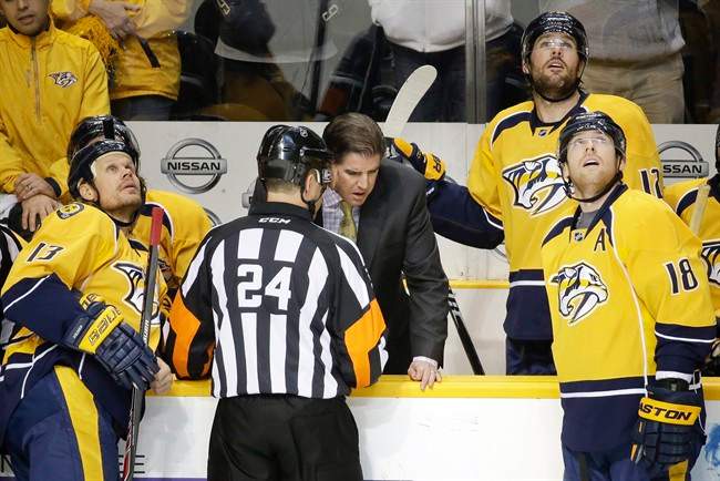 Referee Graham Skiliter (24) explains to Nashville Predators head coach Peter Laviolette why a goal by defenseman Seth Jones, not shown, was waved off in the second period of an NHL hockey game against the Edmonton Oilers Thursday, Nov. 27, 2014, in Nashville, Tenn.