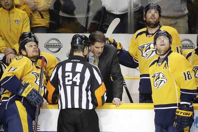 Referee Graham Skiliter (24) explains to Nashville Predators head coach Peter Laviolette why a goal by defenseman Seth Jones, not shown, was waved off in the second period of an NHL hockey game against the Edmonton Oilers Thursday, Nov. 27, 2014, in Nashville, Tenn.