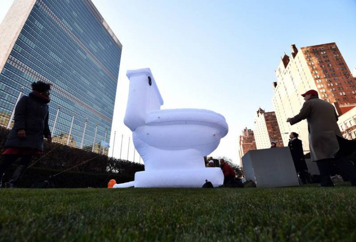 United Nations staff install a 15-foot-high inflatable toilet to mark the World Toilet Day in front of the UN headquarters in New York on November 19, 2014.