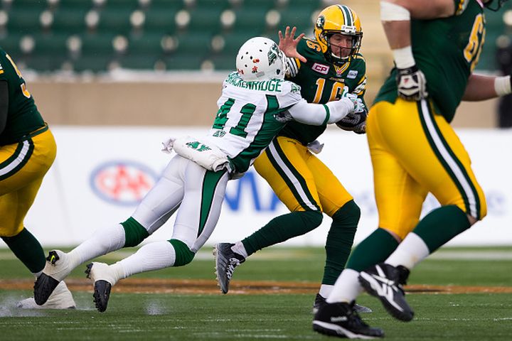 Matt Nichols #16 of the Edmonton Eskimos is tackled for a loss by Tyron Brackenridge #41 of the Saskatchewan Roughriders in the first half of the CFL Western Semi-Final game between the Saskatchewan Roughriders and Edmonton Eskimos at Commonwealth Stadium on November 16, 2014 in Edmonton, Alberta, Canada. 