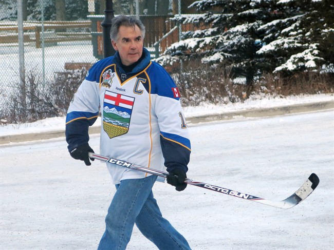 Alberta Premier Jim Prentice plays in a ball hockey game prior to the PC convention in Banff on Friday, November 14, 2014.