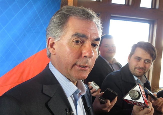 Alberta Premier Jim Prentice tells reporters that his government will balance its budget despite low oil prices, in Banff on Saturday, November 15, 2014. 