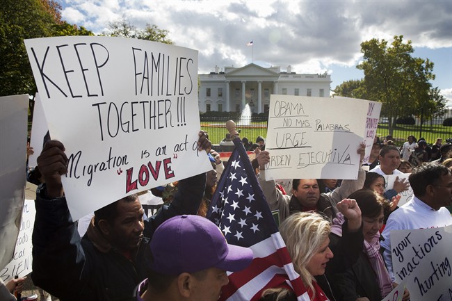 In this Nov. 7, 2014 file photo, people rally for comprehensive immigration reform outside the White House in Washington. 