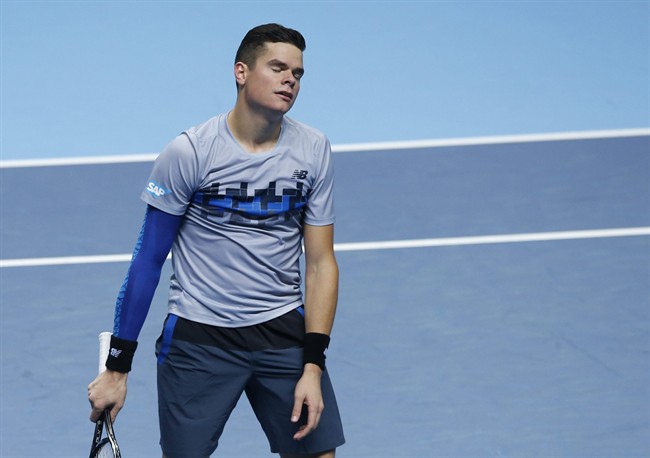 Milos Raonic reacts in frustration after losing a point against Britain’s Andy Murray during their singles ATP World Tour tennis finals match at the O2 arena in London, Tuesday, Nov. 11, 2014. 