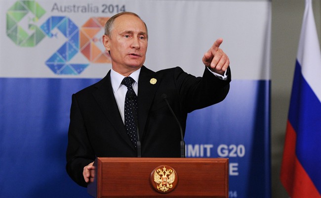 In this photo taken on Saturday, Nov. 15, 2014, Russian President Vladimir Putin speaks to the media before departing from the G-20 summit in Brisbane, Australia. 