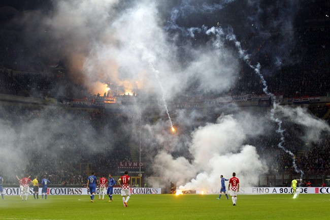 Flares are launched by Croatia supporters during the Euro 2016 qualifying soccer match between Italy and Croatia, at the San Siro stadium in Milan, Italy, Sunday, Nov. 16, 2014. 