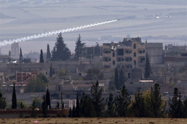 A missile is fired from Islamic State positions in Kobani, seen from a hilltop outside Suruc, on the Turkey-Syria border Thursday, Nov. 6, 2014. 