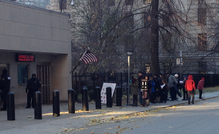 People wait in line outside the U.S. consulate in Toronto on November 14, 2014. 