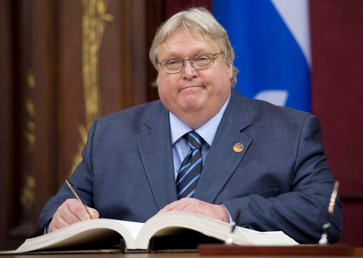 Quebec Health Minister Gaetan Barette is sworn in during a ceremony, Wednesday, April 23, 2014 at the legislature in Quebec City.
