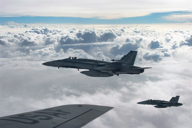 Royal Canadian Air Force CF-18 Hornets depart after refueling with a KC-135 Stratotanker assigned to the 340th Expeditionary Air Refueling Squadron, Thursday, Oct. 30, 2014, over Iraq. 
