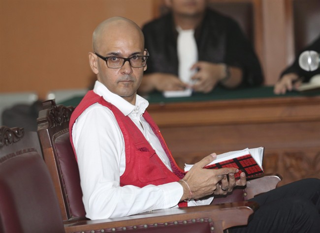 Neil Bantleman sits on the defendant's chair prior to the start of his trial hearing at South Jakarta District Court in Jakarta, Indonesia, Tuesday, Dec. 2, 2014. 