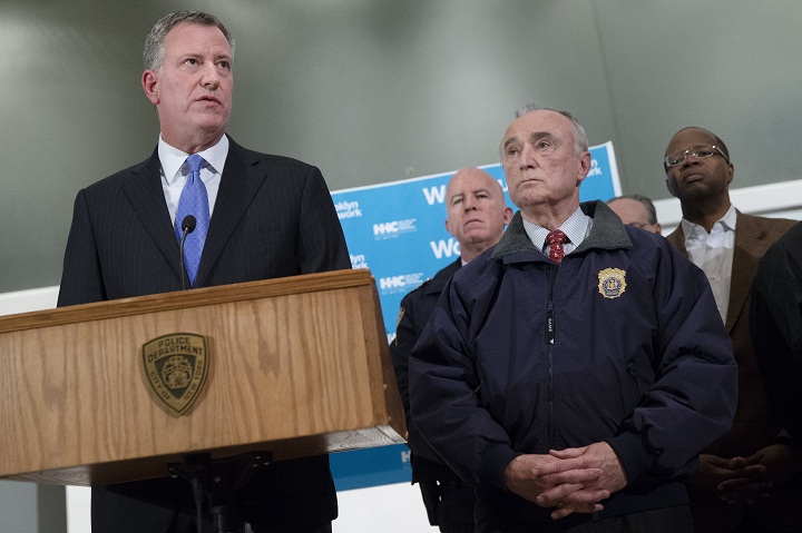 New York City Mayor Bill de Blasio, left, speaks alongside NYPD Commissioner Bill Bratton, right, during a news conference at Woodhull Medical Center, Saturday, Dec. 20, 2014 in New York.