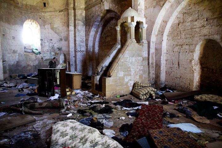 This file photo made on Thursday, May 1, 2014, shows belongings of Syrian rebels inside a chapel at Crac des Chevaliers, the world's best preserved medieval Crusader castle, in Syria.  A U.N. agency says Tuesday, Dec. 23, 2014 that  satellite imagery shows that at least 290 cultural heritage sites in Syria have been damaged by the countrys civil war. 