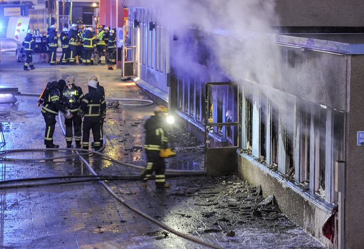 Firemen work outside a still smoking cellar mosque in Eskilstuna, Sweden, Thursday, Dec. 25, 2014. 