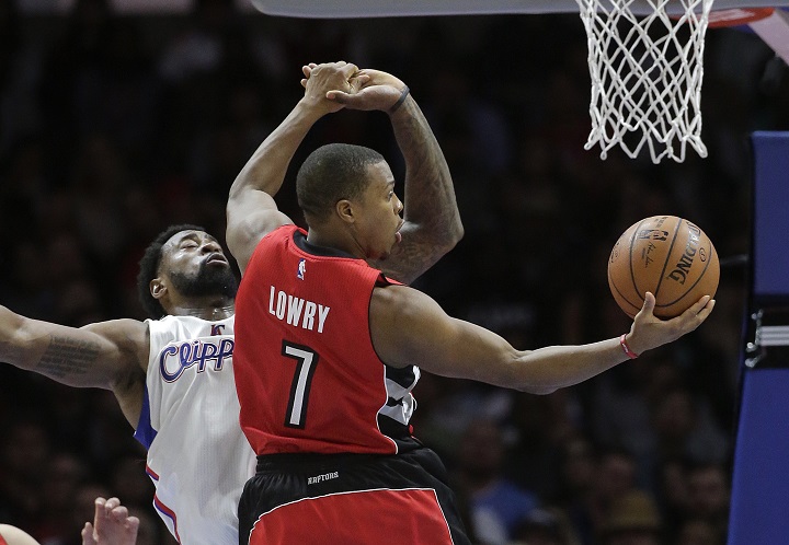 Toronto Raptors' Kyle Lowry, right, goes up for a basket as Los Angeles Clippers' DeAndre Jordan defends during the first half of an NBA basketball game Saturday, Dec. 27, 2014, in Los Angeles. 