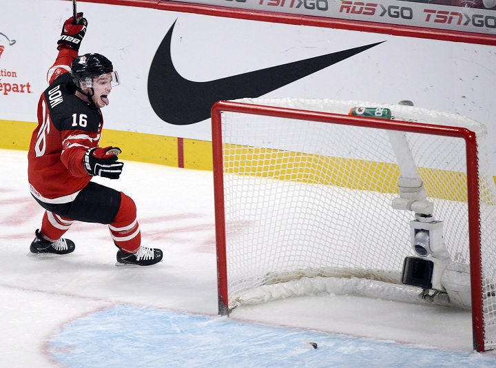 Canada's Max Domi celebrates after scoring the fifth goal against the USA during third period preliminary round hockey action at the IIHF World Junior Championship Wednesday, December 31, 2014 in Montreal. 