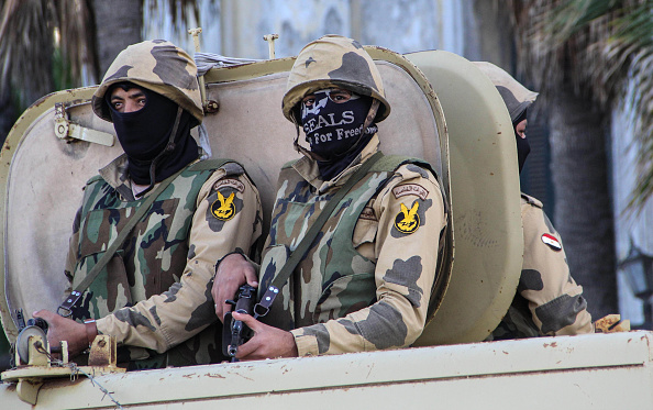 Egyptian soldiers are seen in military vehicles as they take security measures after a group call for an anti-regime rally in Alexandria, Egypt on November 28, 2014. 