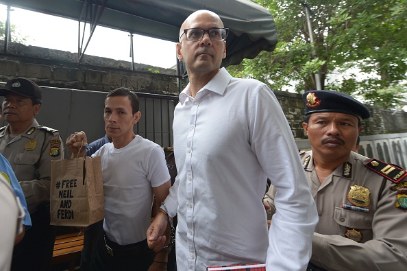 Canadian teacher Neil Bantleman (2nd R) and Indonesian teaching assistant Ferdinand Tjiong (2nd L) arrive at the South Jakarta court in Jakarta on December 2, 2014. Bantleman, who worked at the prestigious Jakarta International School (JIS), was arrested in July along with a teaching assistant during a police investigation into the alleged sexual assault of three kindergarten students. Bantleman and co-accused Ferdinand Tjiong, could face up to 15 years in prison if convicted.