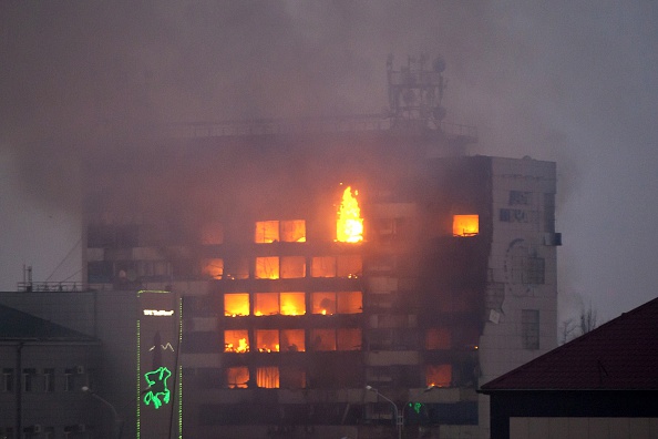 The media building burns as militants attack in central Grozny on December 4, 2014. Several police died in clashes with militants who attacked a traffic post in the Chechen capital Grozny and then stormed a building housing local media, Russian officials said on Thursday.