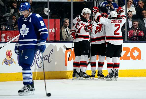  Joffrey Lupul #19 of the Toronto Maple Leafs skates off as the New Jersey Devils celebrate Adam Henrique goal during NHL game action December 4, 2014 at the Air Canada Centre in Toronto, Ontario, Canada.